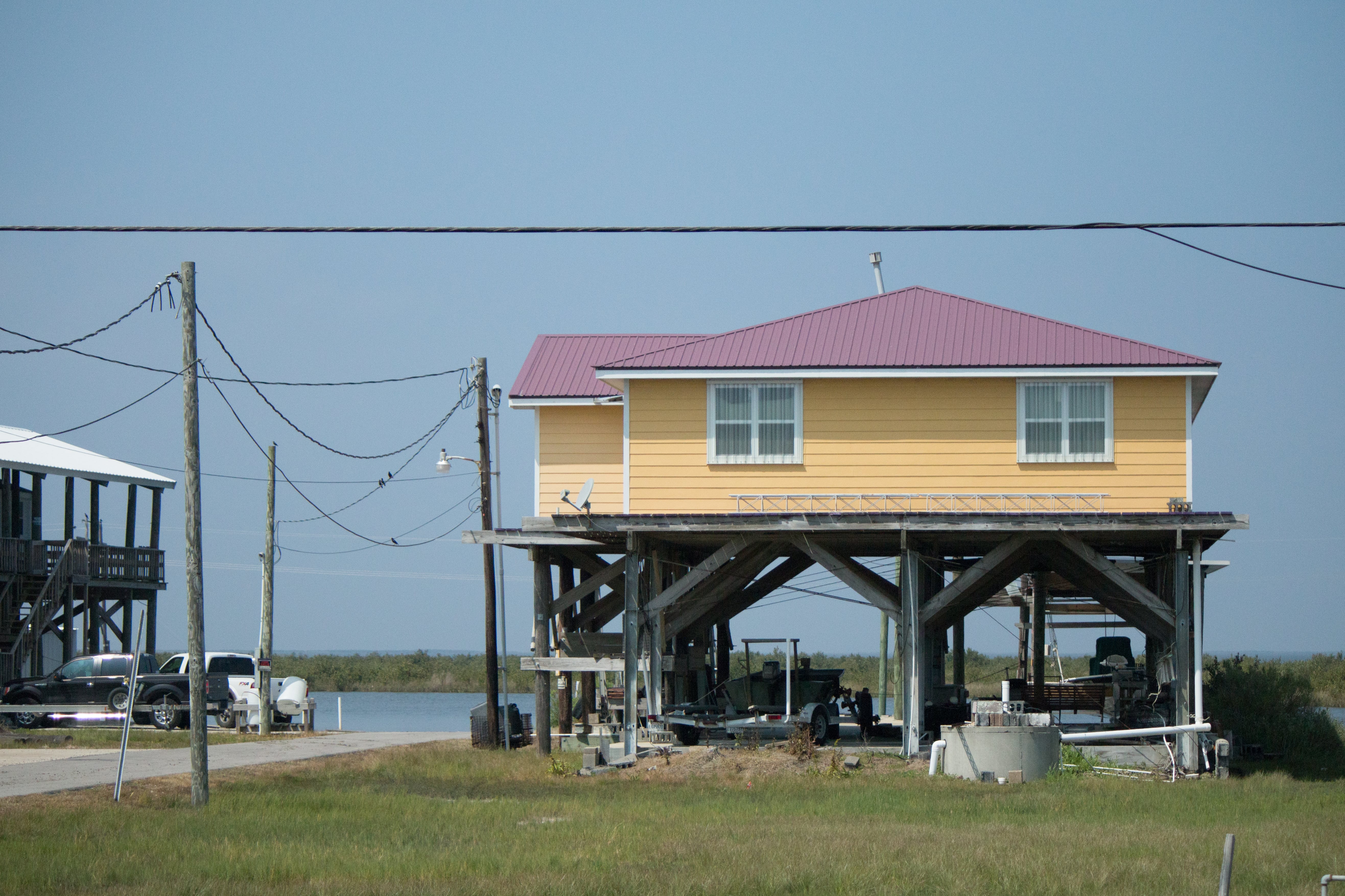 Most of the houses on Grand Isle are raised up on tall stilts to prevent flooding in the event of a hurricane. Grand Isle, a mecca for vacationers, is the only inhabited barrier island in Louisiana.